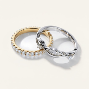 Two diamond wedding rings placed on top of each other from Rare Carat, featured as part of a guide on how do return policies vary among diamond retailers.