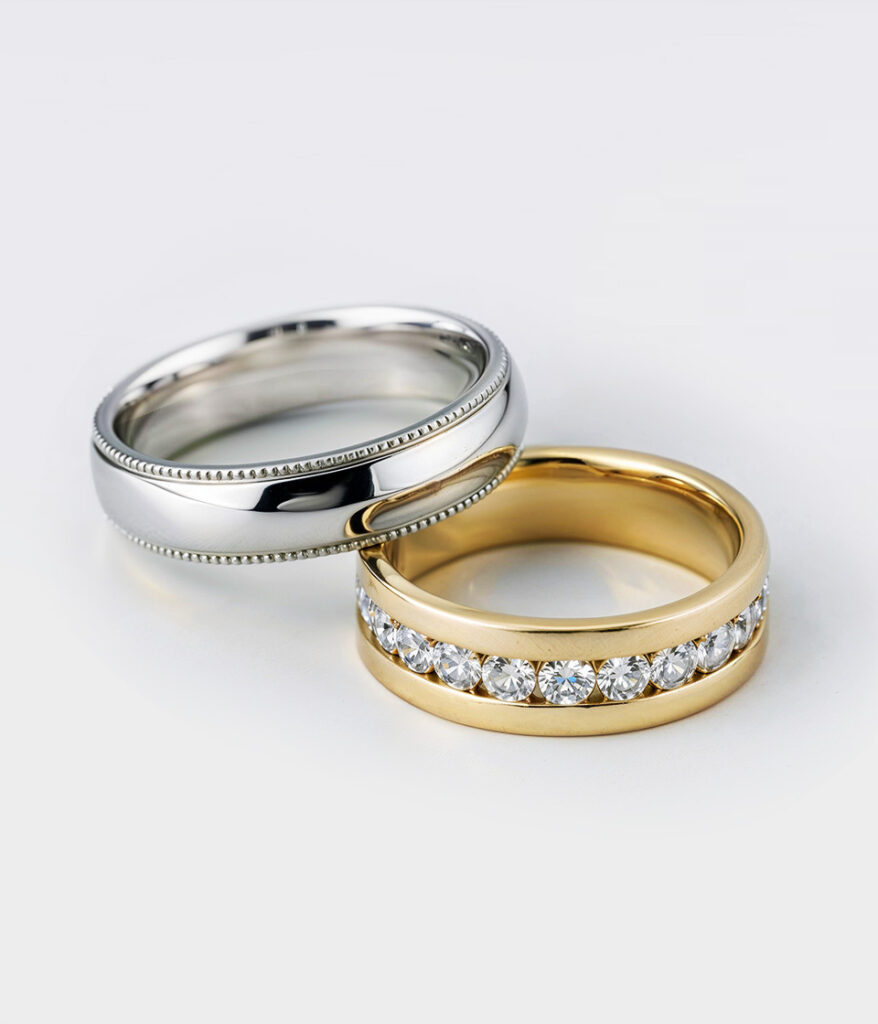 A men's and women's wedding band from Rare Carat, one of the best places to buy wedding bands, displayed on a light-colored surface